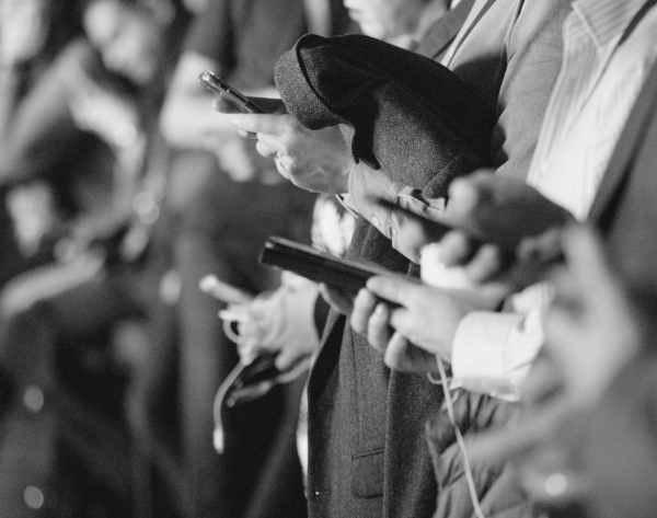 A pair of hands with a phone in their hands.